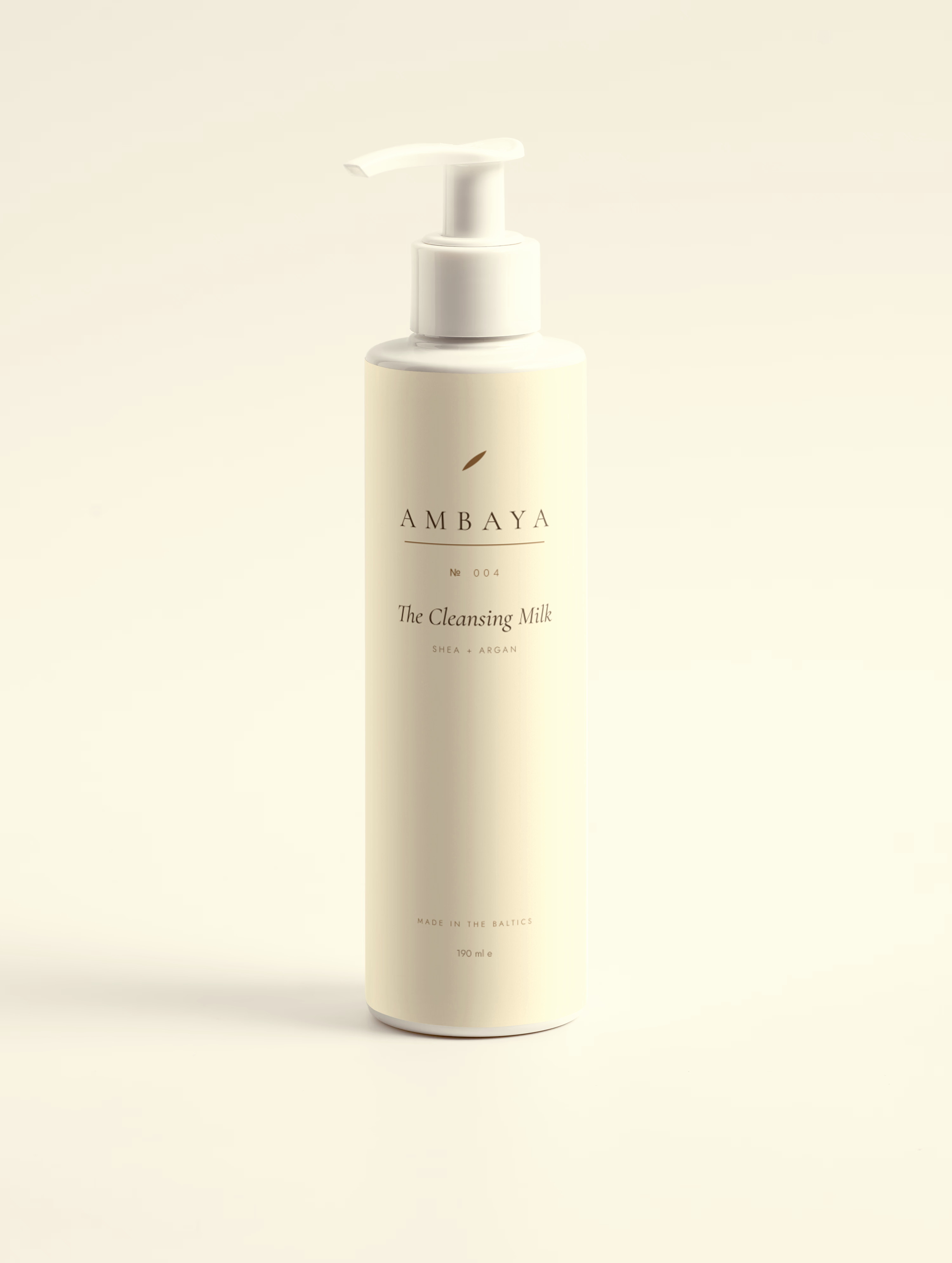 Cream pump bottle of The Cleansing Milk, 190 ml, with the gold AMBAYA wordmark and leaf mark, on a pale cream background.