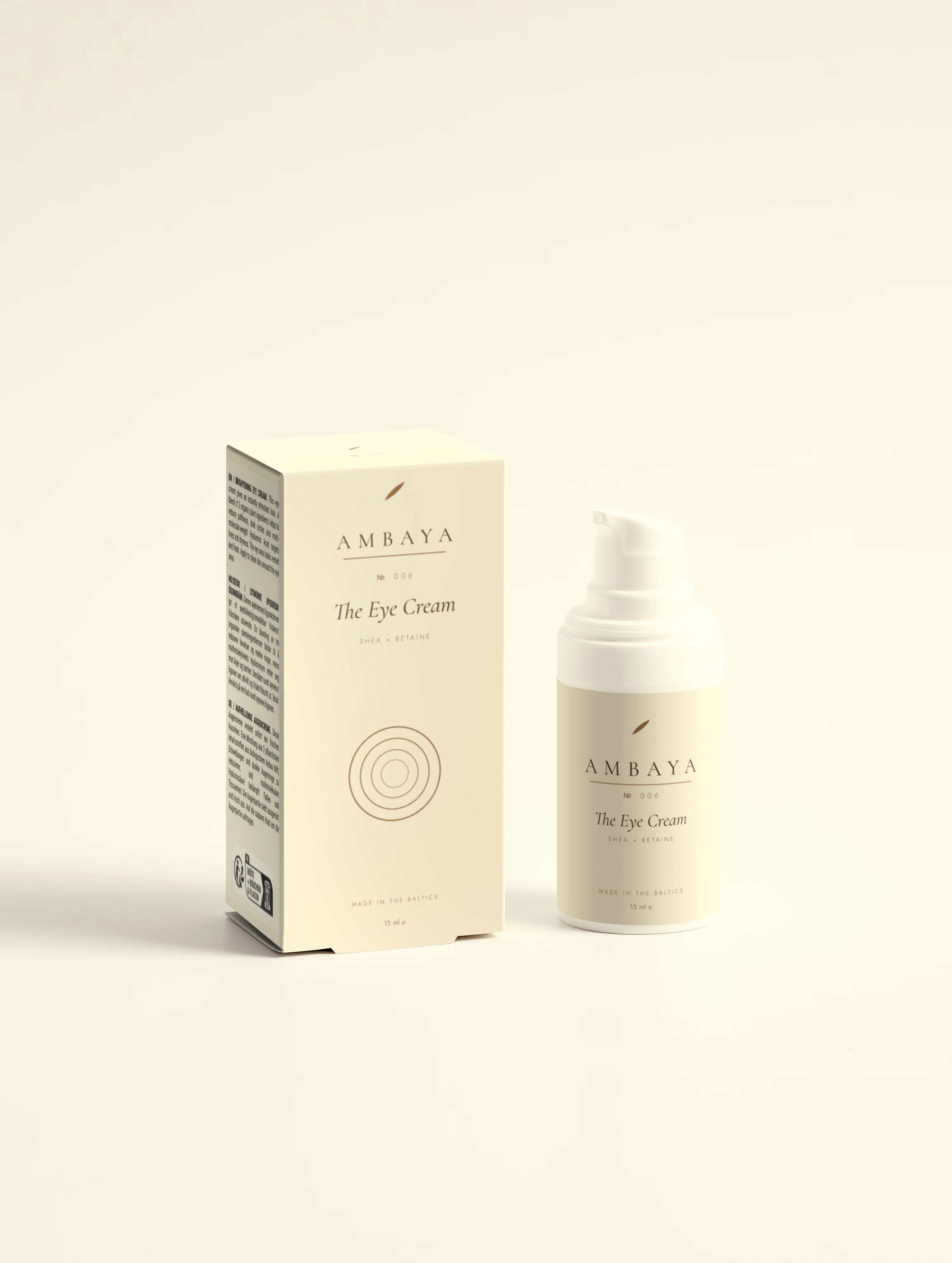 Cream carton and small airless pump bottle of The Eye Cream, 15 ml, with the gold AMBAYA wordmark and leaf mark, on a pale cream background.
