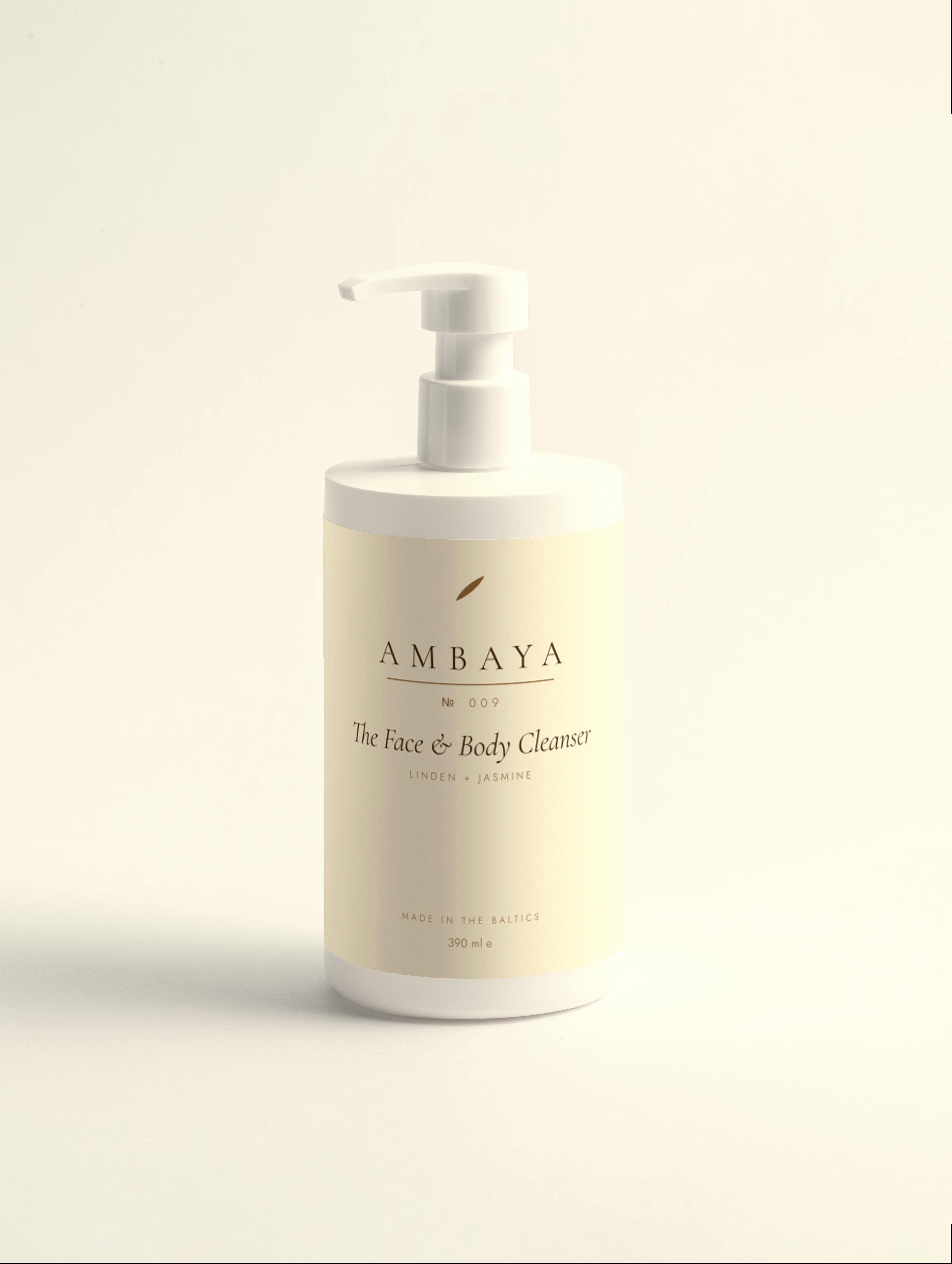 Cream pump bottle of The Face and Body Cleanser, 390 ml, with the gold AMBAYA wordmark and leaf mark, on a pale cream background.