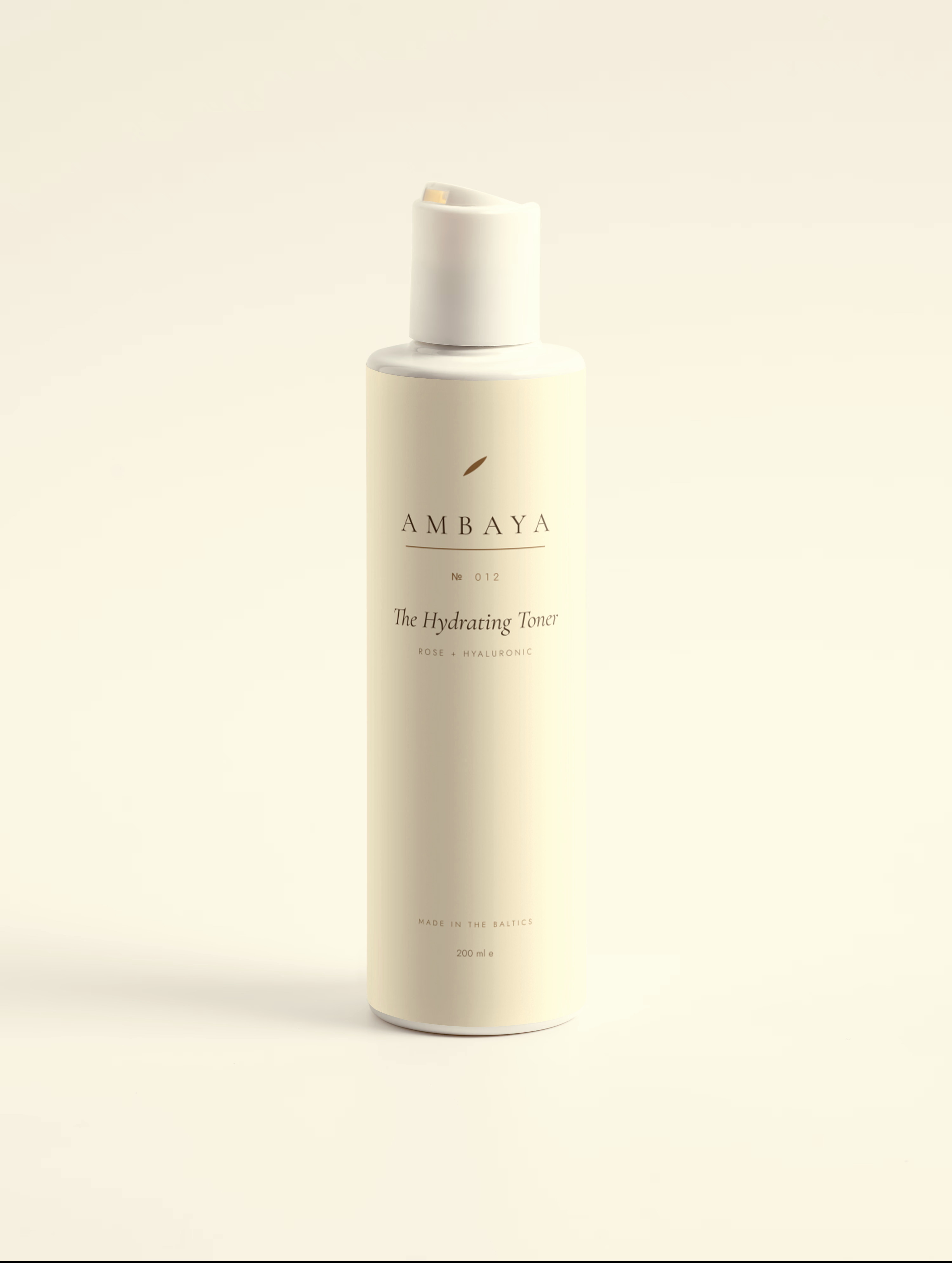 Cream bottle of The Hydrating Toner, 200 ml, with a white disc cap and the gold AMBAYA wordmark, on a pale cream background.